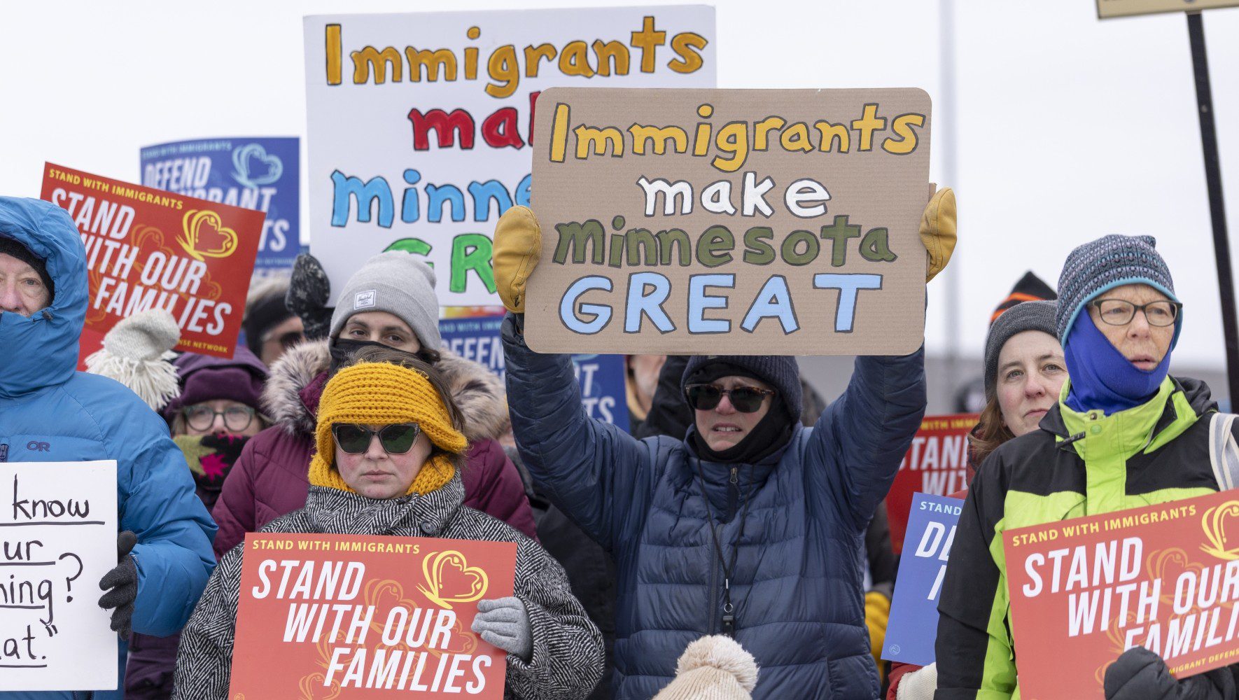 Community members hold banners as they show up to a press conference to demand accountability from Target after ICE agents were spotted staging at the parking lot in Minneapolis, Minnesota, U.S., on December 4, 2025. (Christopher Juhn/Anadolu via Getty Images)