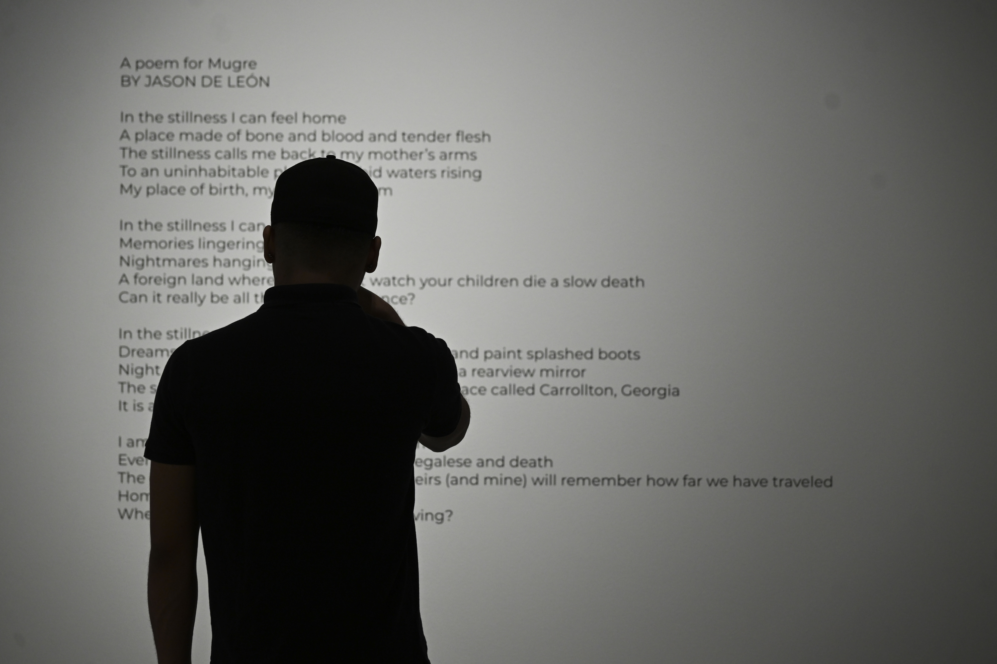 A visitor reads a poem by Jason De León, the...