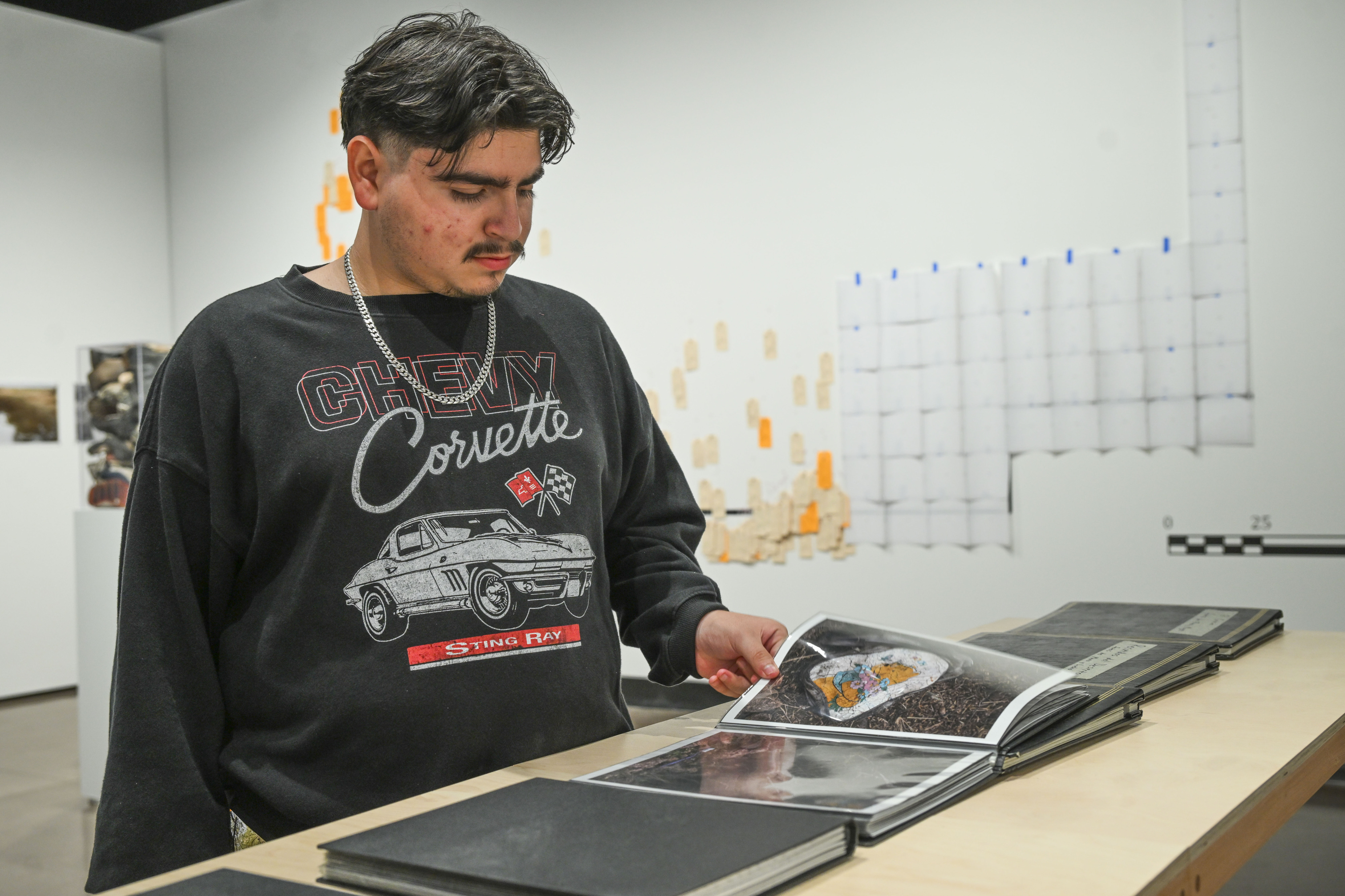 Daniel Urrutia, a student at Chaffey College, looks through photographs...