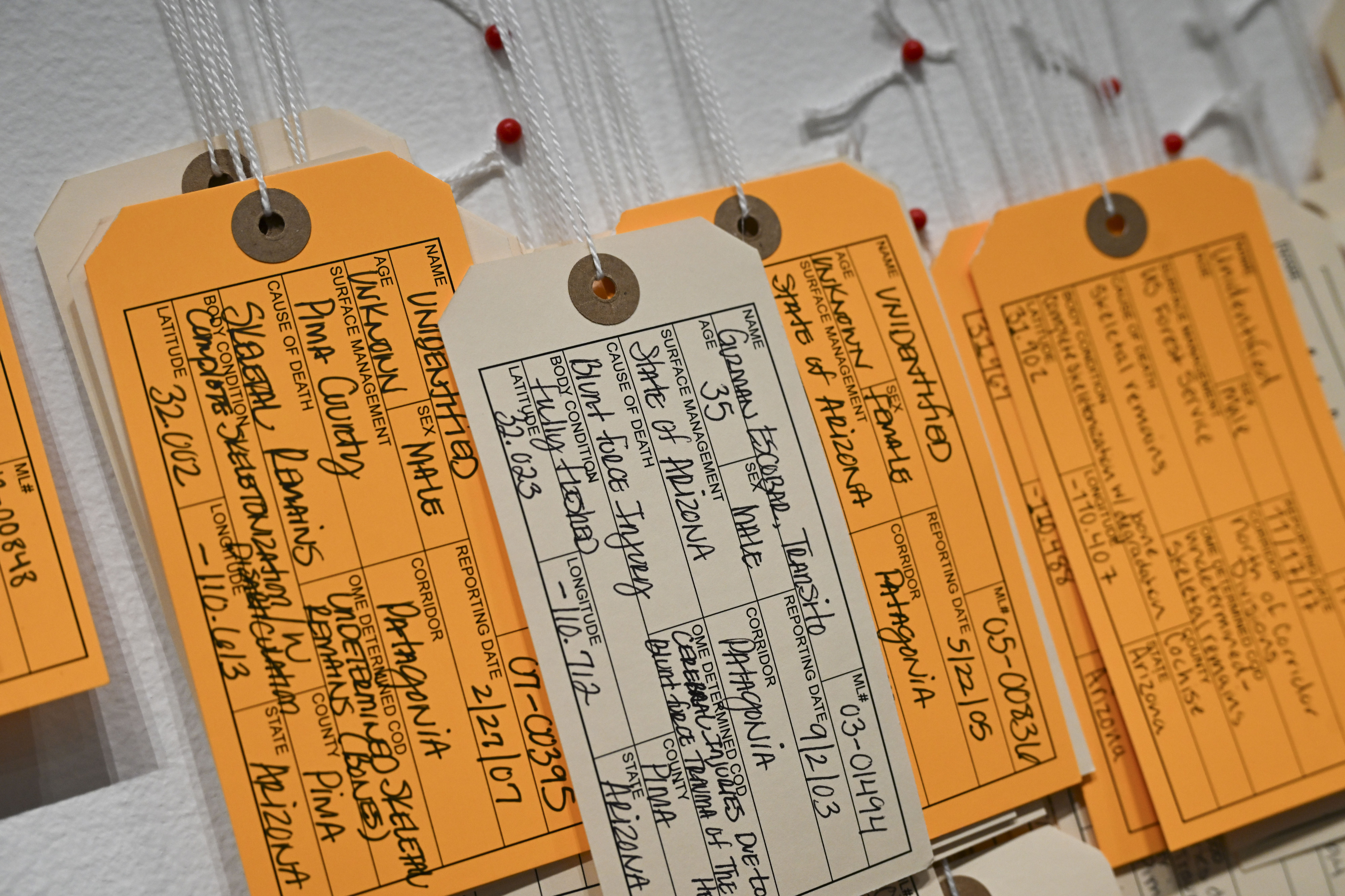 Written tags documenting traveling migrants who have died along their...