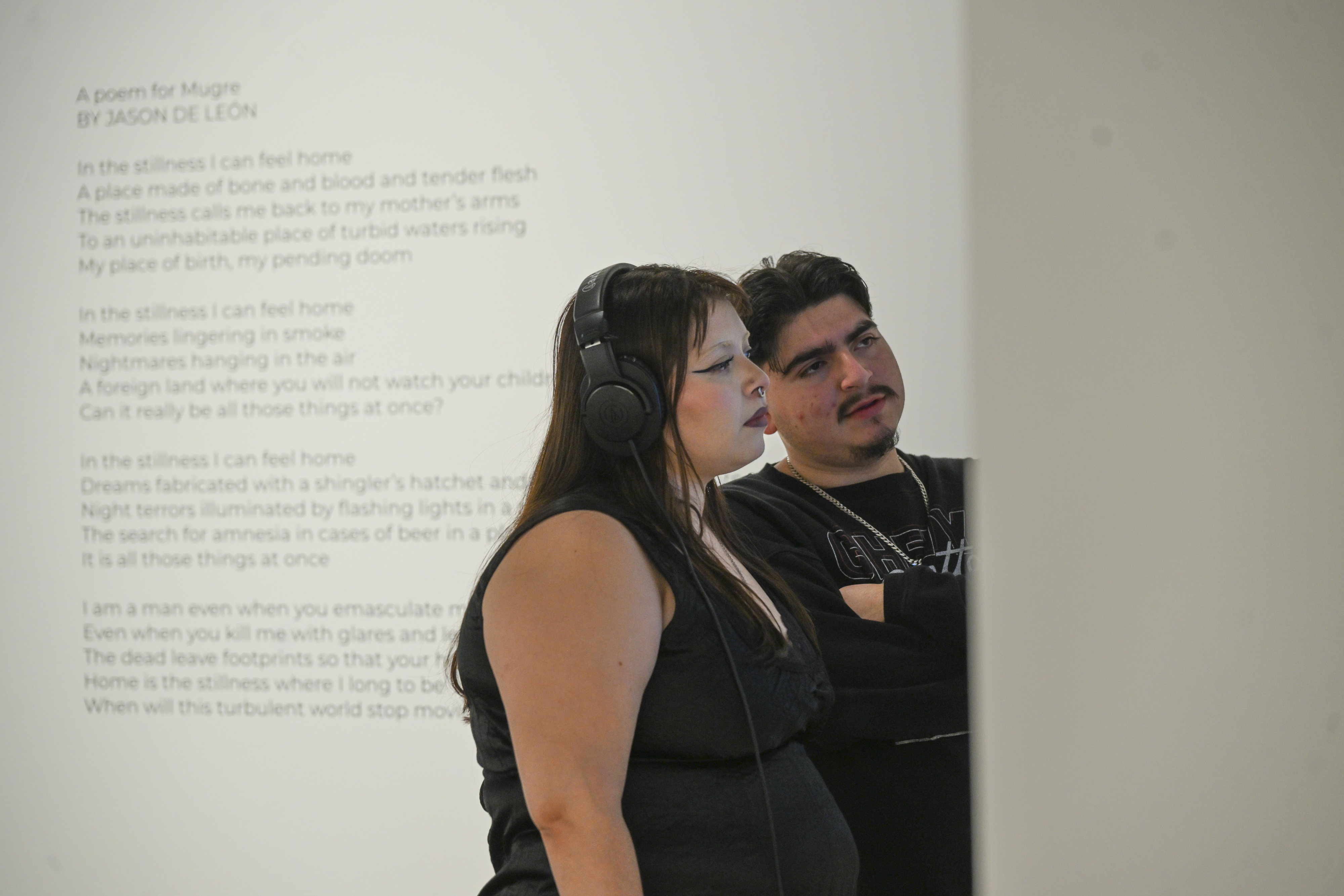Students, from left, Dania and Daniel Urruita listen to an...
