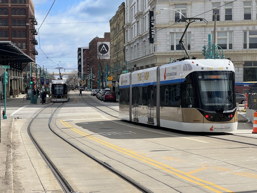 Two The Hop streetcars pass each on E. St. Paul Ave. Photo by Jeramey Jannene.