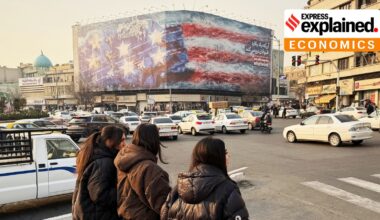 A billboard showing a US aircraft carrier with damaged jets on its deck, and sign reading: "If you sow the wind, you'll reap whirlwind," at the Enqelab-e-Eslami square, in Tehran, Iran, Jan. 25, 2026.