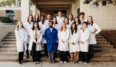 Group photo including Professor Alexis Komor
