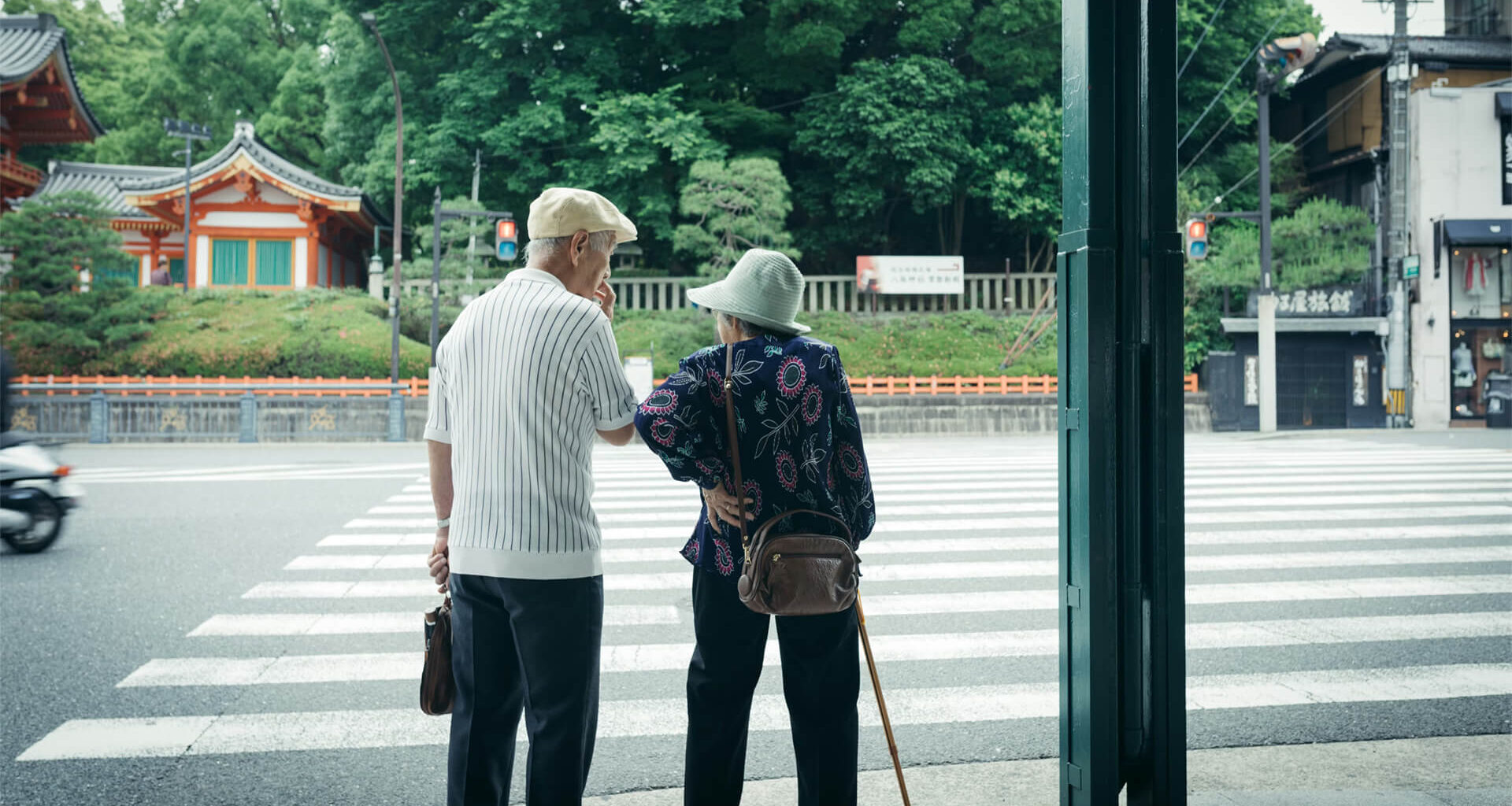 A Japanese elderly couple at a crosswalk