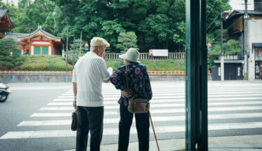 A Japanese elderly couple at a crosswalk