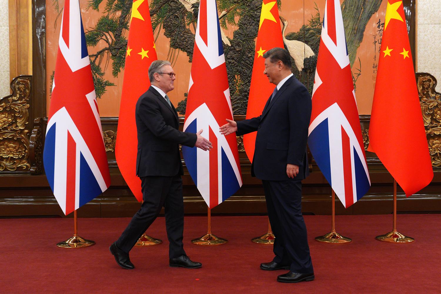 British Prime Minister Keir Starmer is seen shaking hands with Chinese President Xi Jinping.