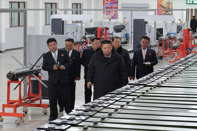 In this photo provided by the North Korean government, its leader Kim Jong Un, front right, visits a major munitions factory at an undisclosed place in North Korea Saturday, Jan. 3, 2026.