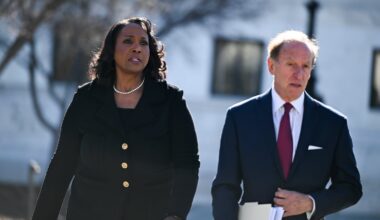 Lisa Cook and attorney Abbe Lowell walked outside the Supreme Court on Wednesday.
