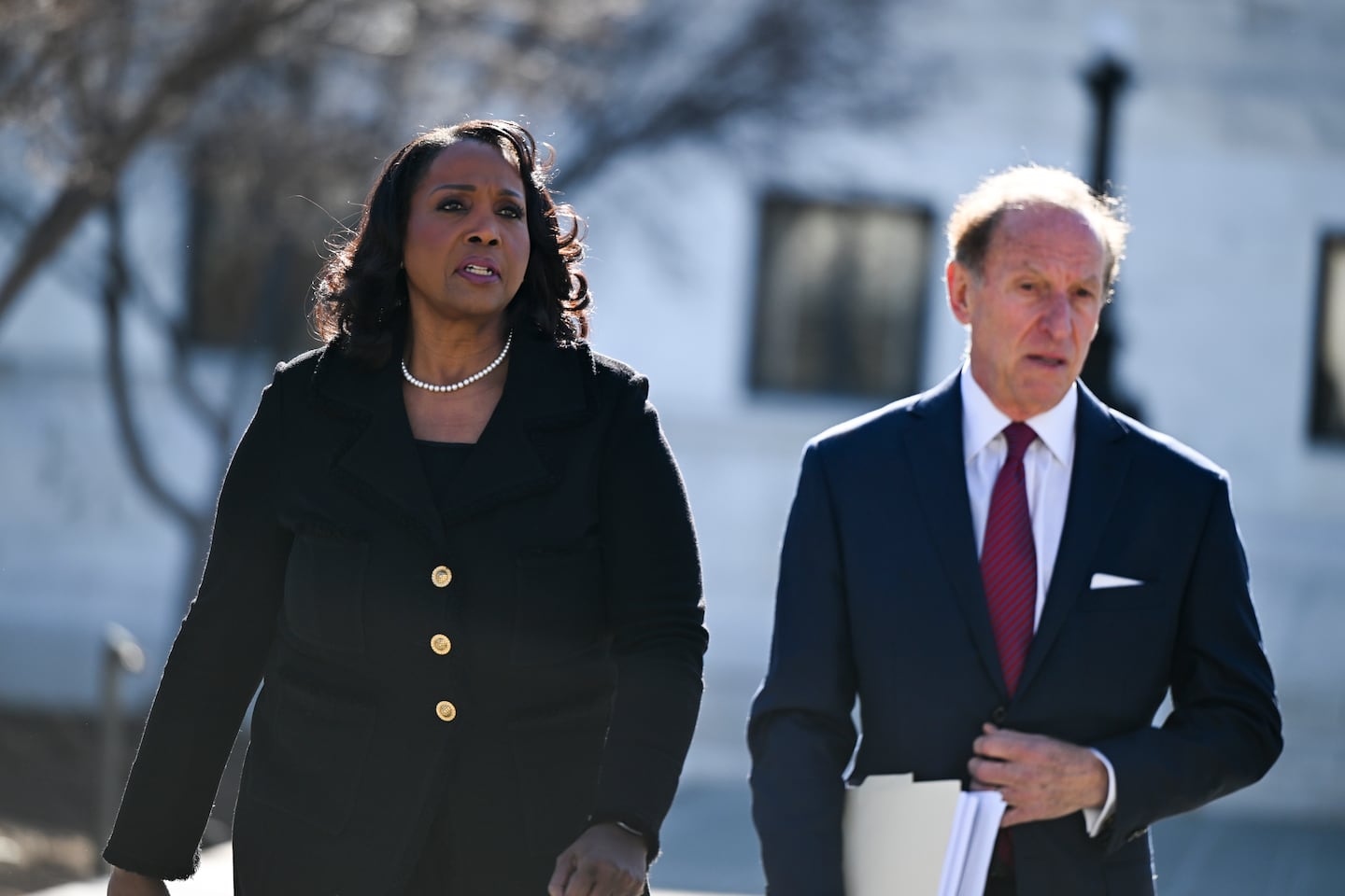 Lisa Cook and attorney Abbe Lowell walked outside the Supreme Court on Wednesday.
