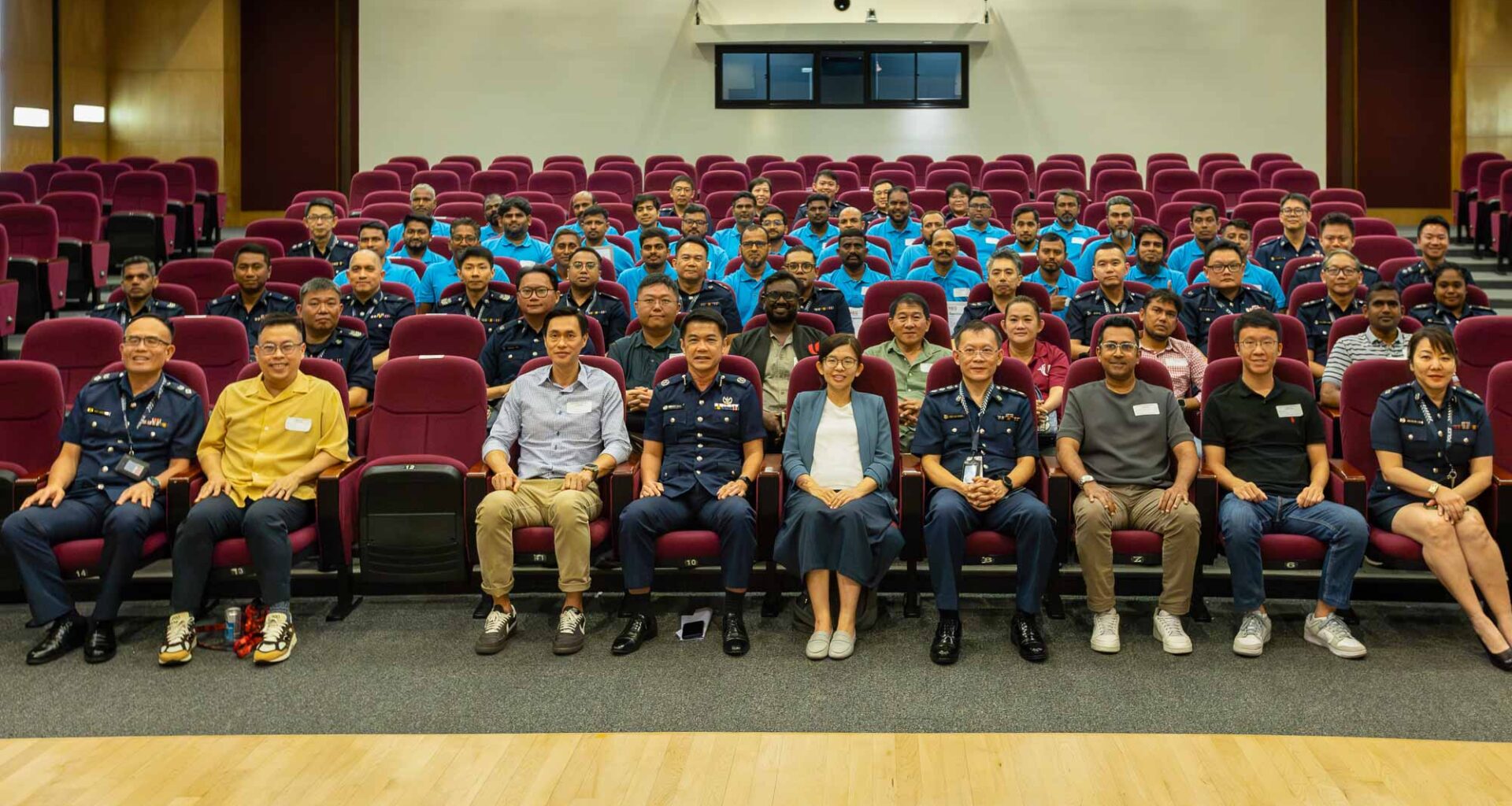 A group photo of Police officers, migrant worker ambassadors and representatives from relevant agencies