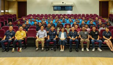 A group photo of Police officers, migrant worker ambassadors and representatives from relevant agencies