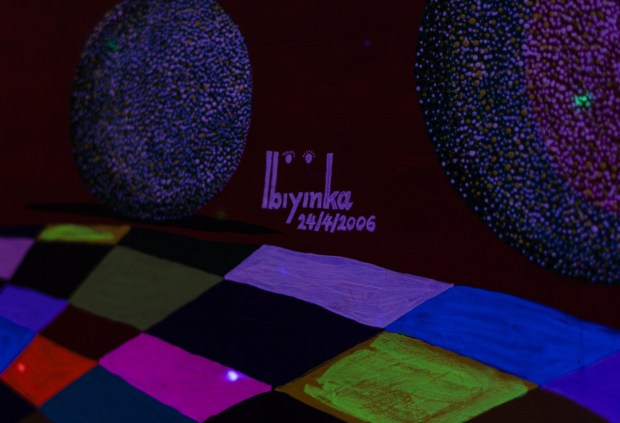 Ibiyinka Alao's signature on one of his painting in the Art Space in the Classroom Building at Penn State Schuylkill, Thursday, Jan. 22, 2026. (MATTHEW PERSCHALL/MULTIMEDIA EDITOR)