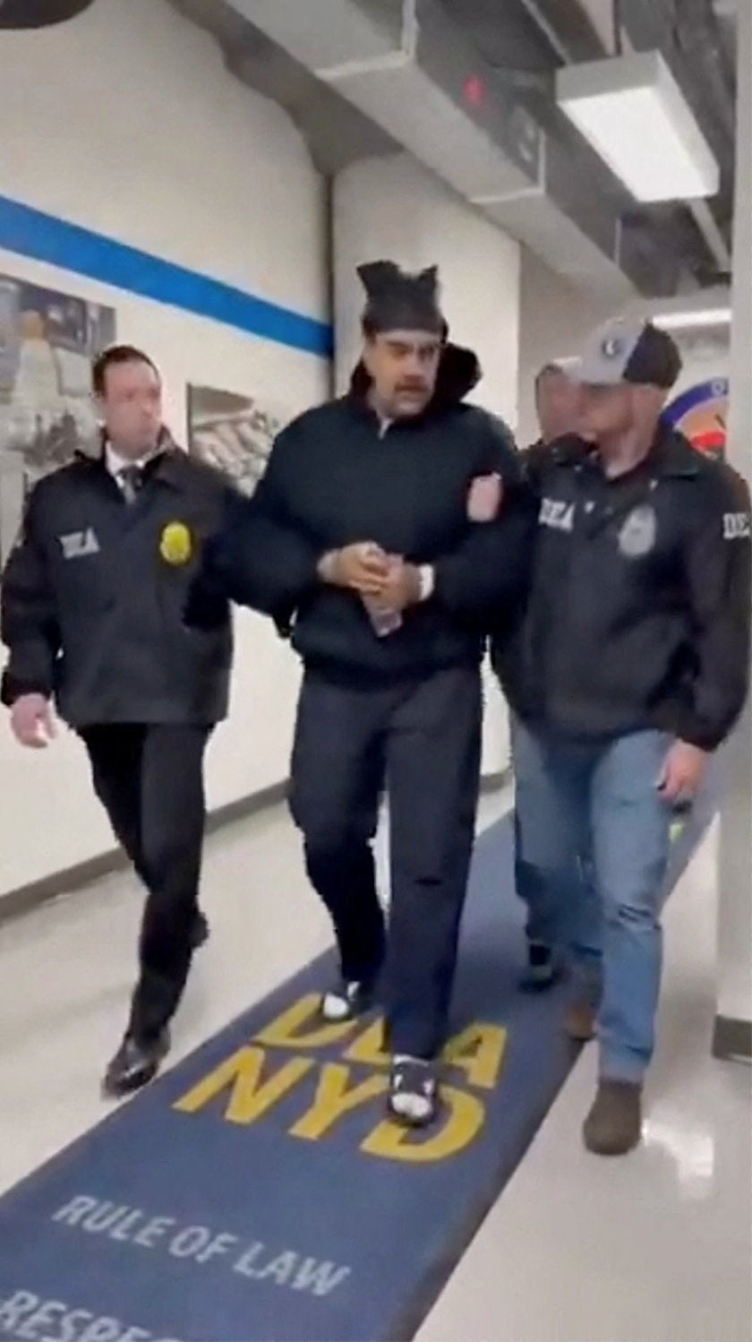 A still image from video posted by the White House's Rapid Response 47 account on X.com, which originated from the @PaulDMauro account, shows Venezuela's President Nicolas Maduro being walked in custody down a hallway at the offices of the U.S. Drug Enforcement Administration (DEA) in New York City, U.S., January 3, 2026.