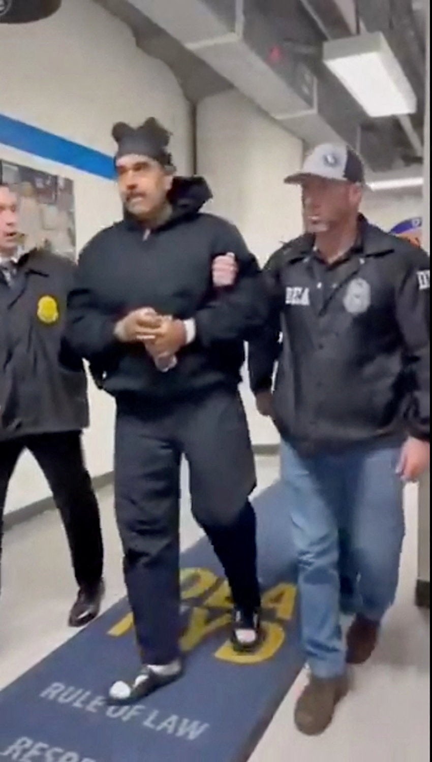 A still image from video posted by the White House's Rapid Response 47 account on X.com, which originated from the @PaulDMauro account, shows Venezuela's President Nicolas Maduro being walked in custody down a hallway at the offices of the U.S. Drug Enforcement Administration (DEA) in New York City, U.S., January 3, 2026.