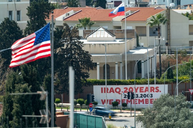 A large banner is displayed on the outer wall of the Russian embassy in Nicosia facing the US embassy with both countries' flags in the picture on March 21, 2023. - Iraq on March 20 marked 20 years since the start of the US-led invasion that toppled dictator Saddam Hussein, but no official celebrations were held. (Photo by David VUJANOVIC / AFP) (Photo by DAVID VUJANOVIC/AFP via Getty Images)