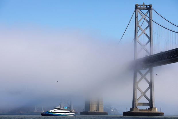 FILE PHOTO A ferry passes by, as a layer of fog partially obscures a portion of the Bay Bridge, in a view from the Embarcadero in San Francisco, Calif., on Oct. 28, 2021. (Anda Chu/Bay Area News Group)
