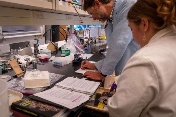 Dr. Peter Scott Weiss-Penzias of UC Santa Cruz and a student looking at data in his lab in UC Santa Cruz, Calif. on Nov. 6, 2025. (Photo by Daniella Garcia Almeida)