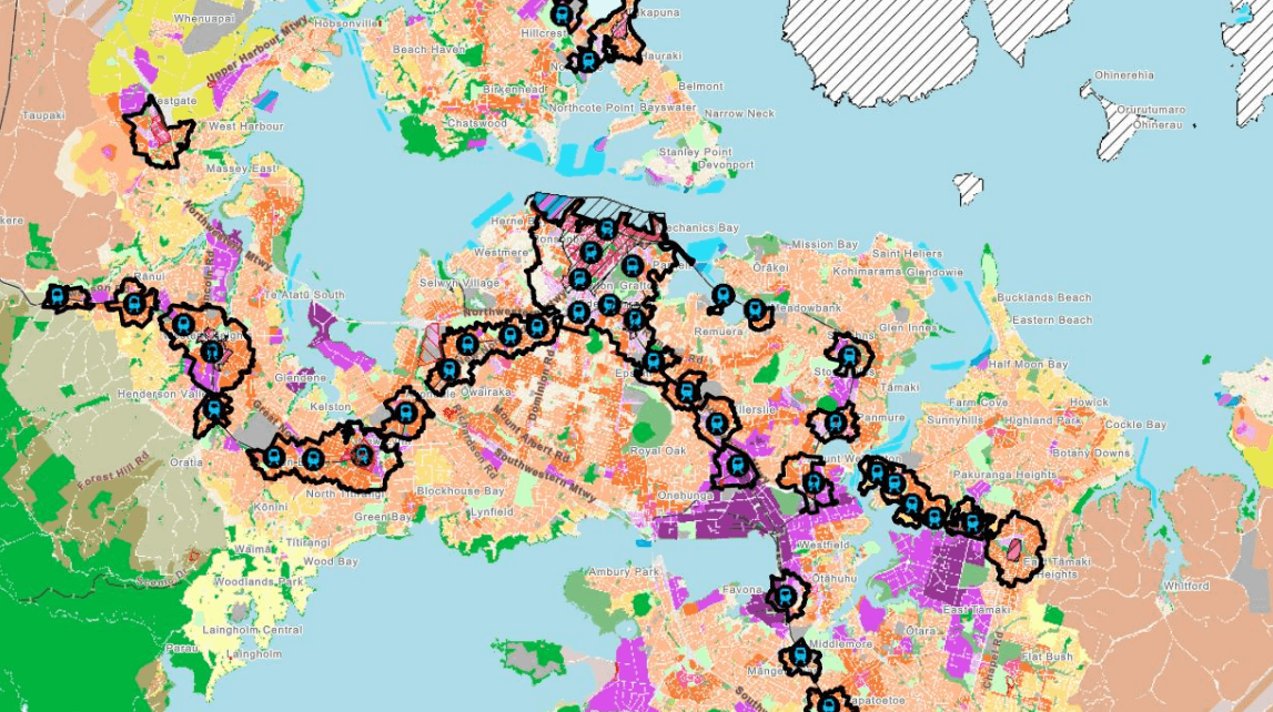 A colorful, detailed map of a city and surrounding areas, with various regions shaded in different colors. A black dashed line marked with blue symbols winds through the map, connecting several points of interest.