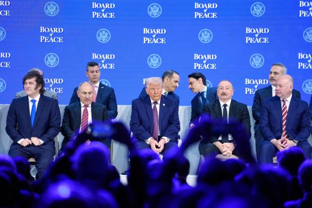 President Trump sits on the podium during a session on the Board of Peace initiative of US President Donald Trump at the Annual Meeting of the World Economic Forum in Davos, Switzerland, Thursday, Jan. 22, 2026. (AP Photo/Markus Schreiber)