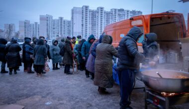 People who had no power at home following Russia's air attacks waited in line to receive free hot meals in a residential neighborhood in Kyiv on Friday.