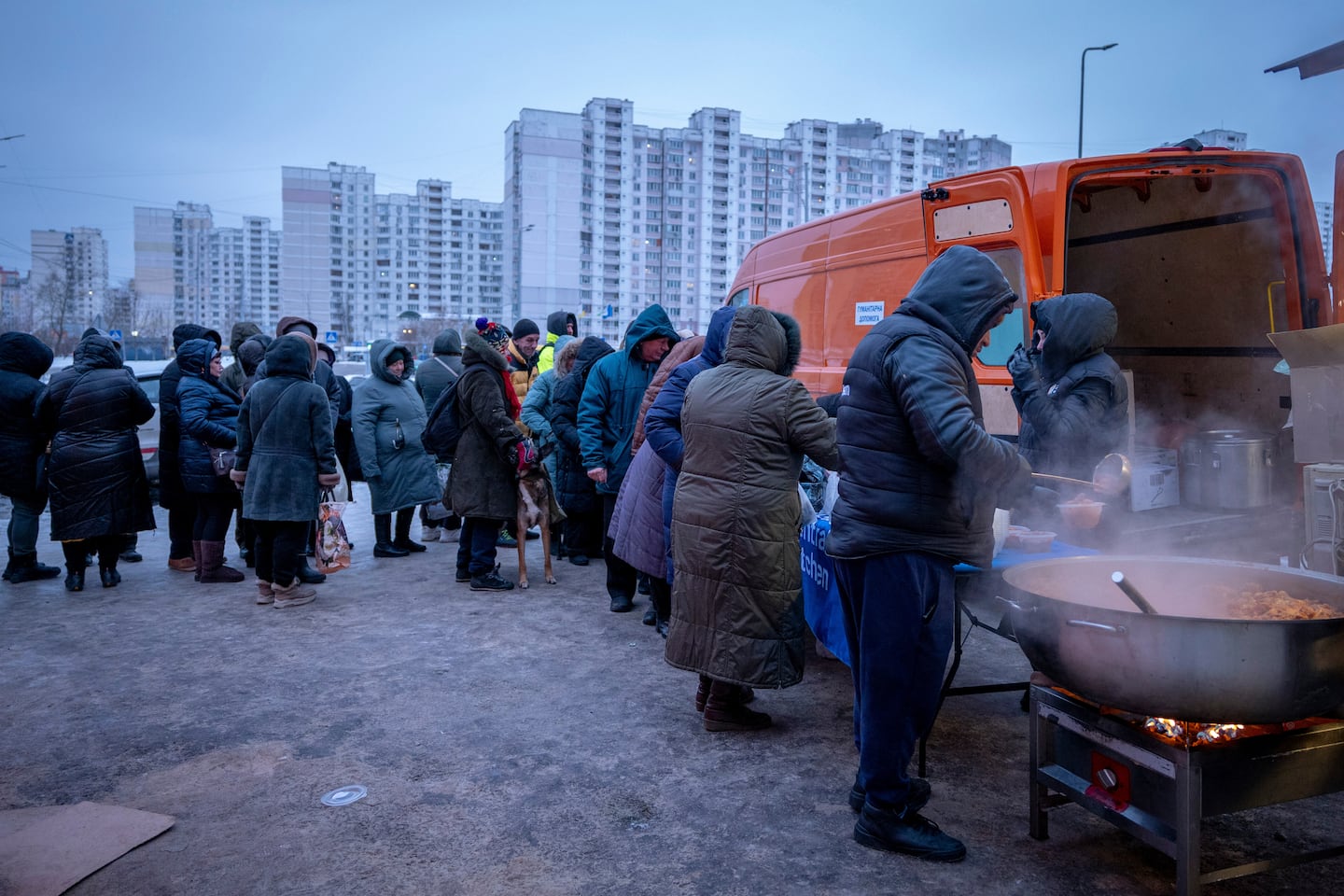 People who had no power at home following Russia's air attacks waited in line to receive free hot meals in a residential neighborhood in Kyiv on Friday.