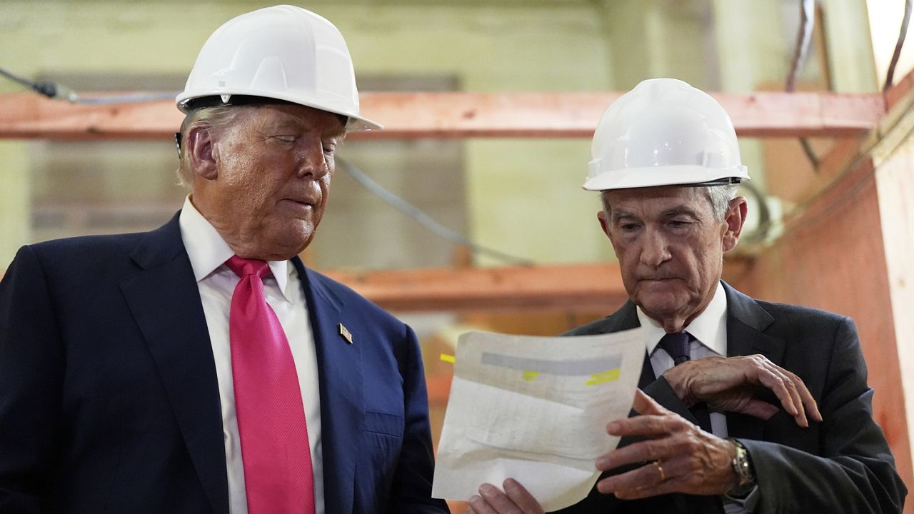 Federal Reserve Chairman Jerome Powell, right, and President Donald Trump look over a document of cost figures during a visit to the Federal Reserve, July 24, 2025, in Washington. (AP Photo/Julia Demaree Nikhinson, File)