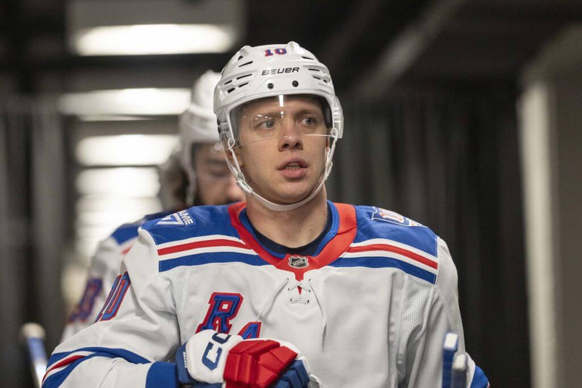 Artemi Panarin walks down the tunnel with teammates behind him.