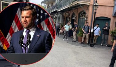 A man in a suit speaks at a podium with microphones and US flags behind him; inset in the corner of an image showing several people standing and waiting along a street lined with buildings.