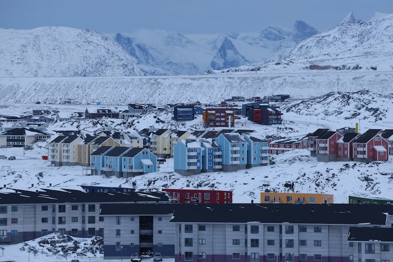 Residential apartment buildings stand among snow on January 21 in Nuuk, Greenland.