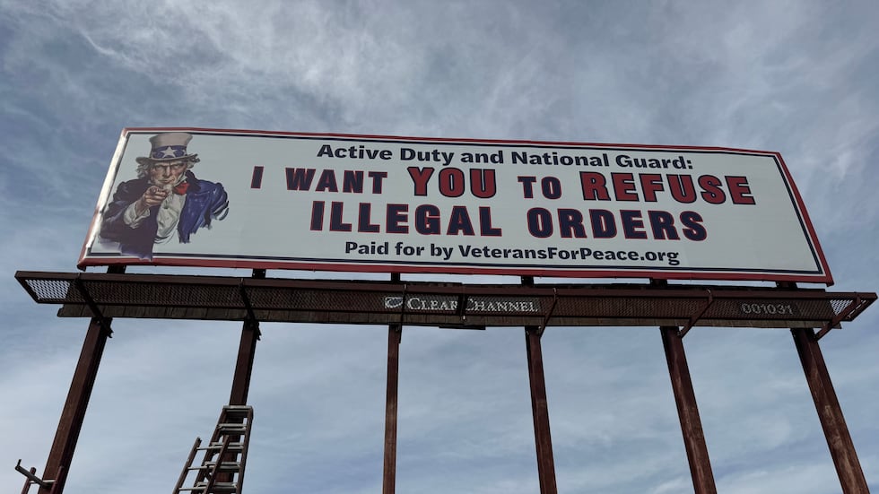 The sign reads, “Active duty and National Guard: I want you to refuse illegal orders,” and...