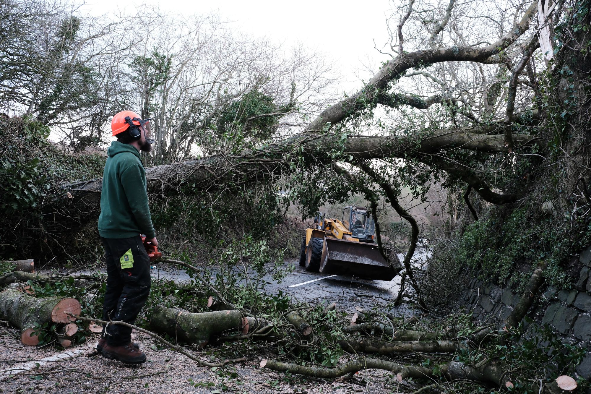 A fallen tree is cleared from a road in St Stephen, Cornwall.
