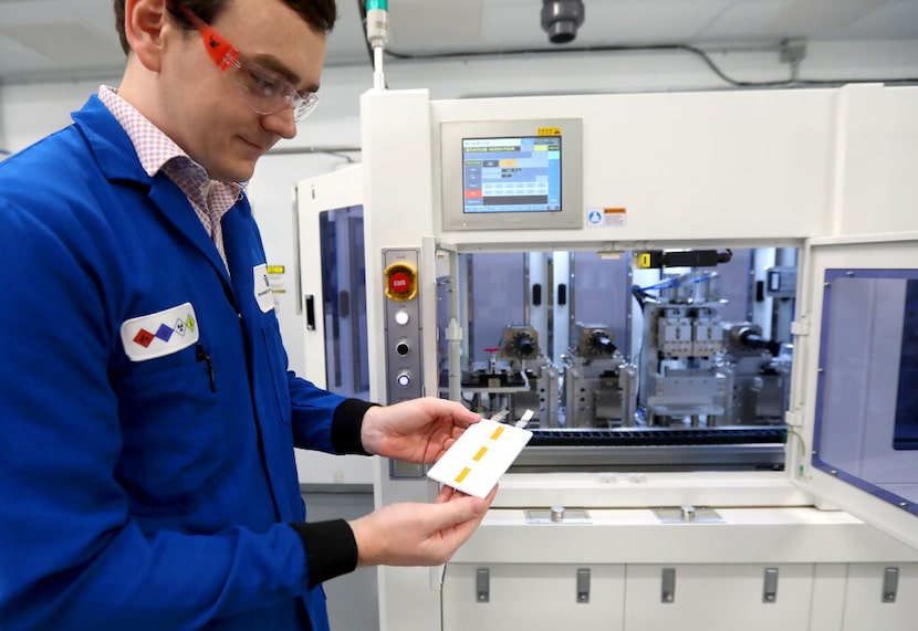 Quentin Nelson holds a flat pack battery at UTD's Batteries and Energy to Advance...