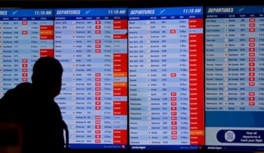 A man checked cancellations noted on the departures board in Terminal B at Logan on Jan. 25, 2026.