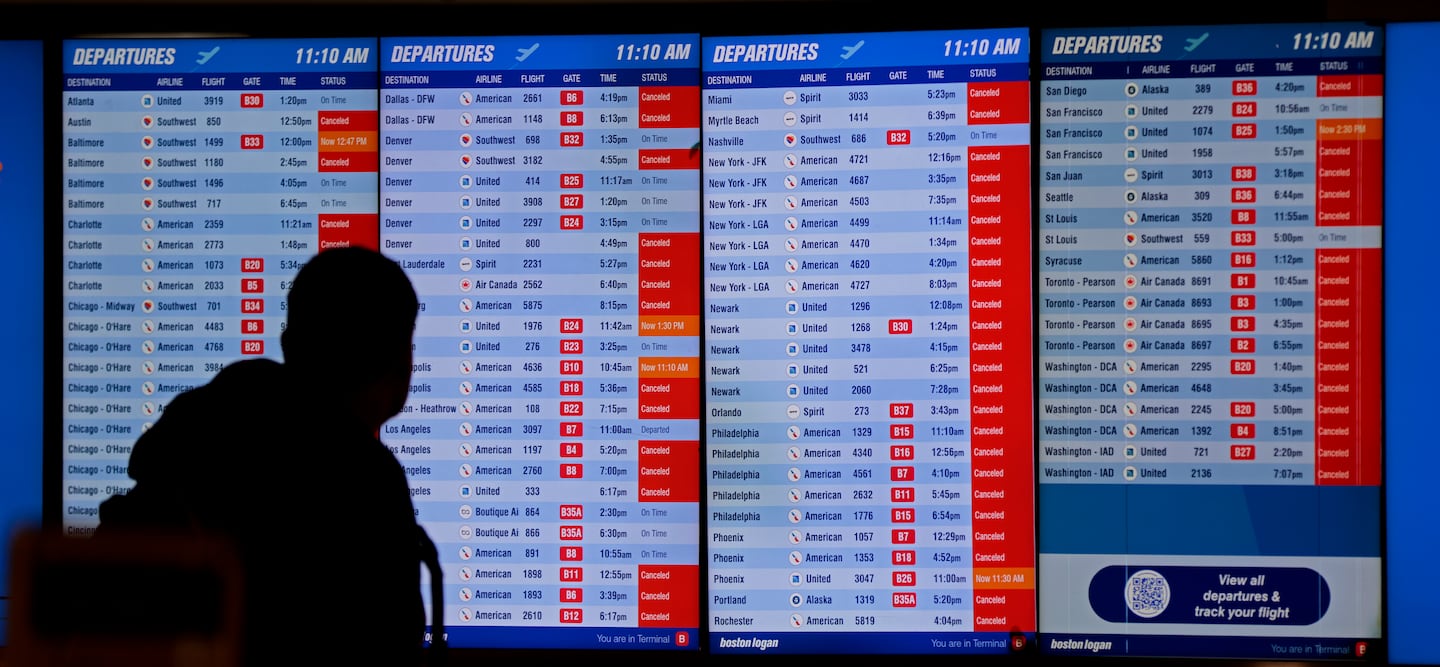 A man checked cancellations noted on the departures board in Terminal B at Logan on Jan. 25, 2026.