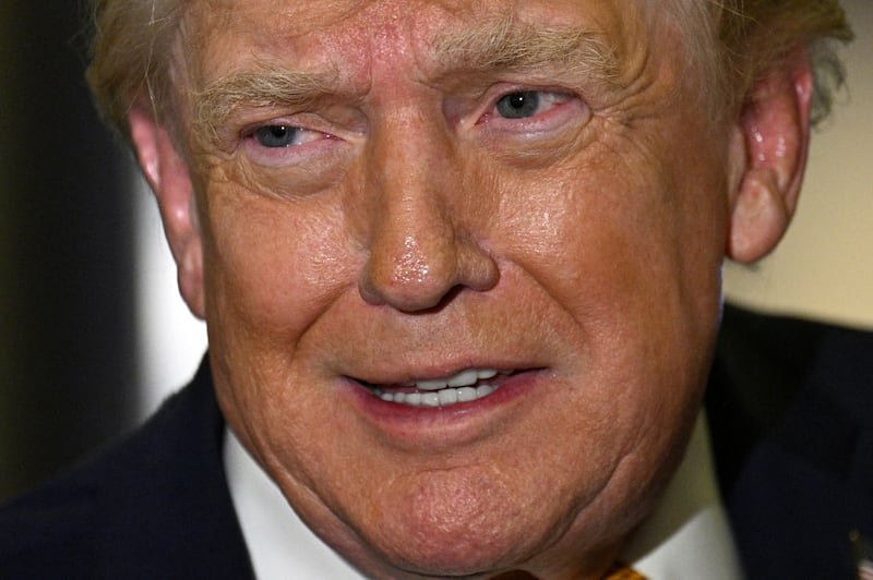 US President Donald Trump speaks with reporters aboard Air Force One on his way back to Washington, DC, on January 4, 2026. President Trump is returning to DC after spending the holidays at his Mar-a-Lago residence in Palm Beach, Florida. (Photo by Jim WATSON / AFP via Getty Images)
