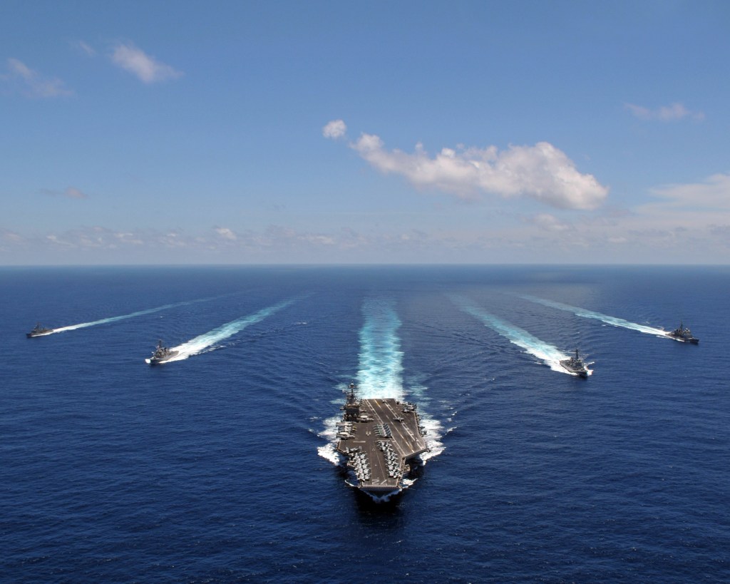 The aircraft carrier USS Abraham Lincoln leads a formation of ships from its Strike Group as they transit the Indian Ocean.