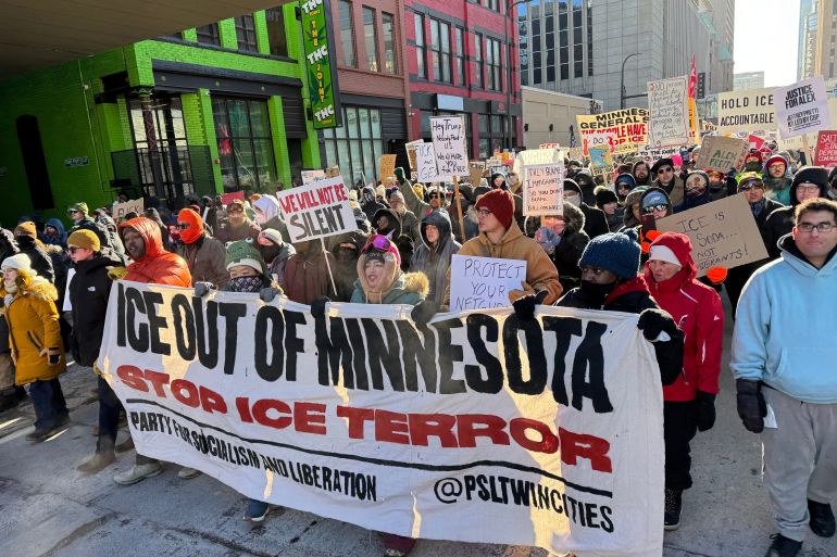 People participate in an anti-ICE rally Sunday, Jan. 25, 2026, in Minneapolis. (AP Photo/Jack Brook)