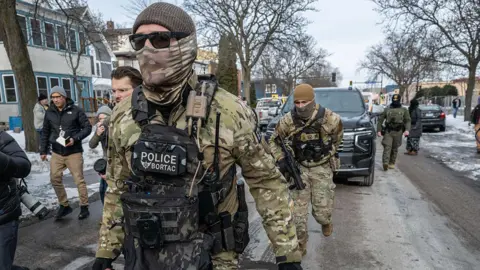 Bloomberg via Getty Images Federal law enforcement agents patrol in Minneapolis, Minnesota, US, on Sunday, Jan. 11, 2026