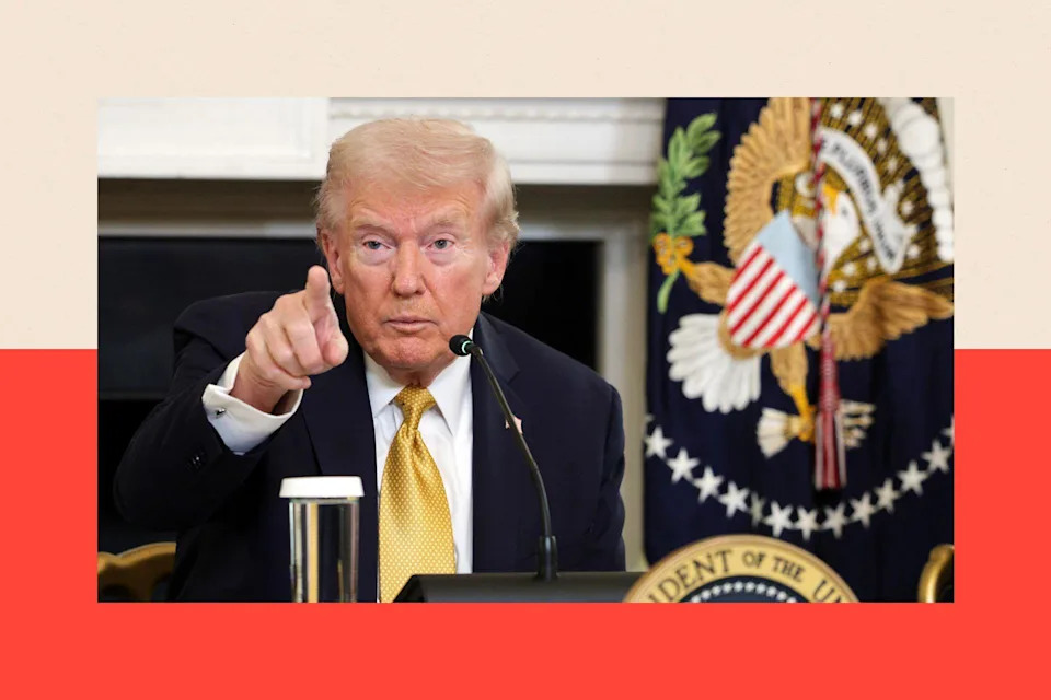 President Donald Trump points as he takes a question from a reporter 