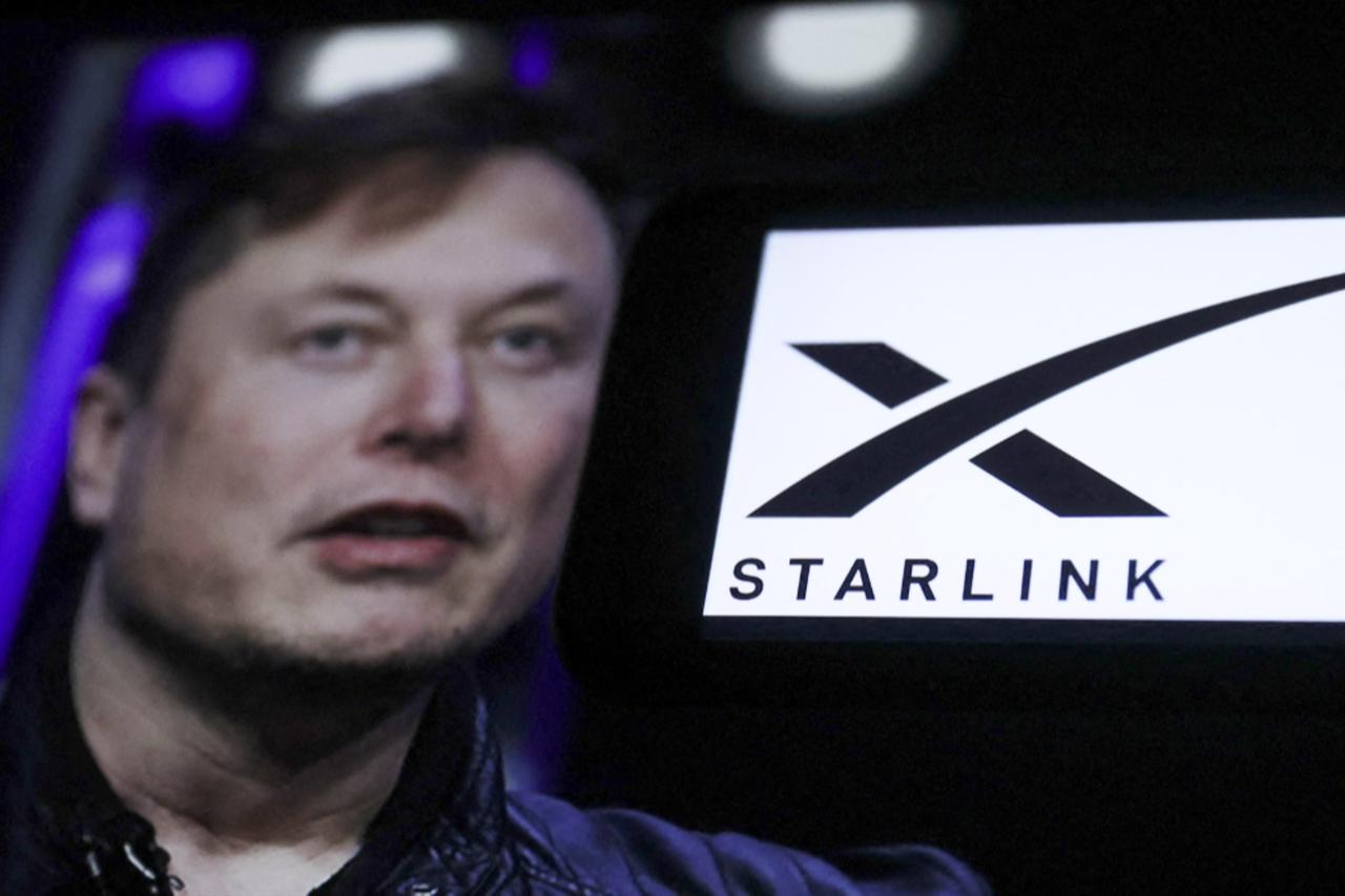 Elon Musk with the Starlink satellite logo in the background during an event, 2023. (AFP Photo)