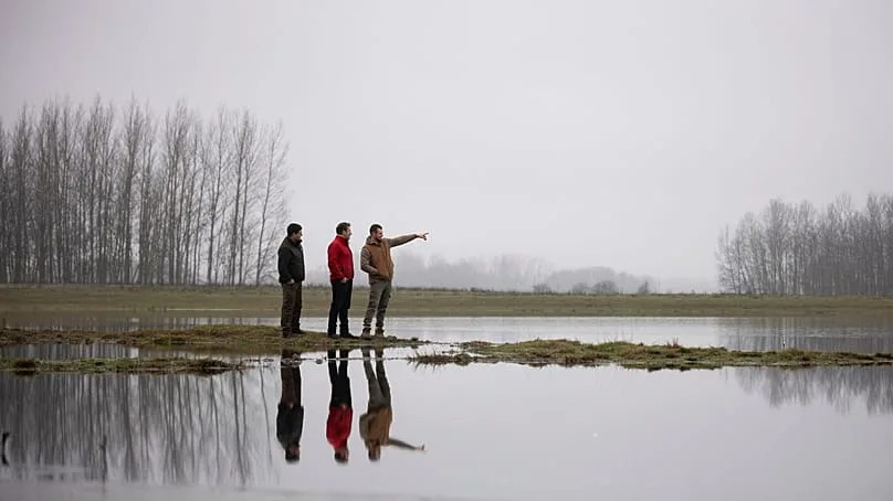 Members of the water guardians group talk next to an artificial lake in Kiskunmajsa, Hungary, 12 December 2025. 