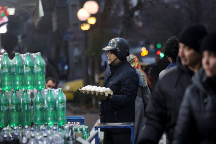 An Iranian man shops in a local market as protests erupt over the collapse of the currency's value in Tehran, Iran, January 5, 2026. Majid Asgaripour/WANA (West Asia News Agency) via REUTERS. An Iranian man shops in a local market as protests erupt over the collapse of the currency's value in Tehran, Iran, January 5, 2026. Majid Asgaripour/WANA (West Asia News Agency) via REUTERS.