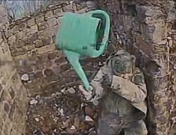 A russian soldier trying to defend himself with a water can, most likely not successful.