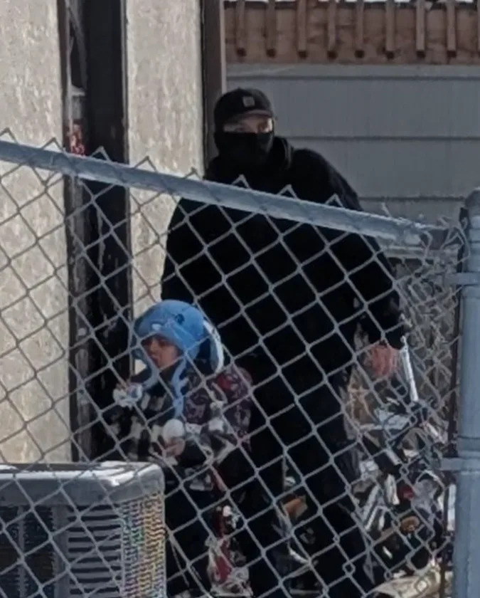 An image showing 5-year-old Liam Ramos with a federal immigration agent outside his home in Minnesota on Tuesday, Jan. 20.