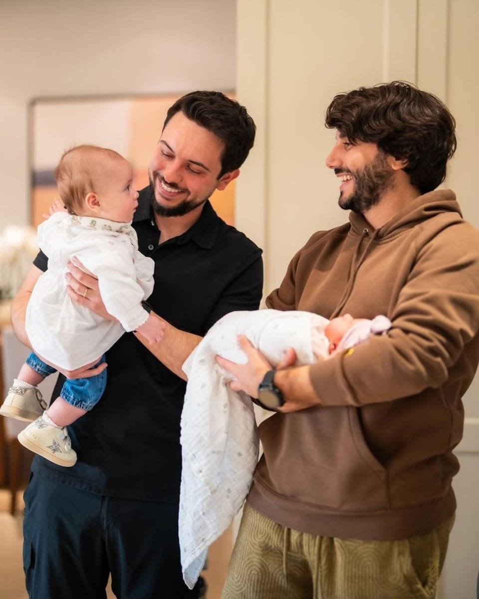 Hussein of Jordan holds his daughter Iman, while Jameel of Jordan holds his daughter Amina