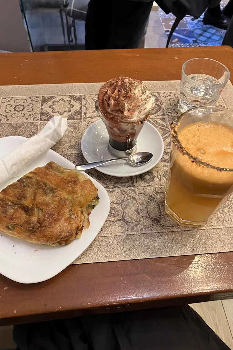 Pastry, coffee and strawberry topped drinks.