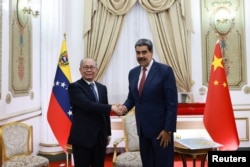 Maduro's last diplomatic engagement, with Chinese envoy Qiu Xiaoqi, at the Miraflores Palace, in Caracas, Venezuela, January 2, 2026.