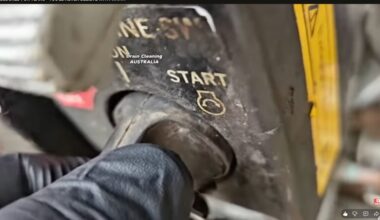 gloved hand turning on a turbo jet motor.
