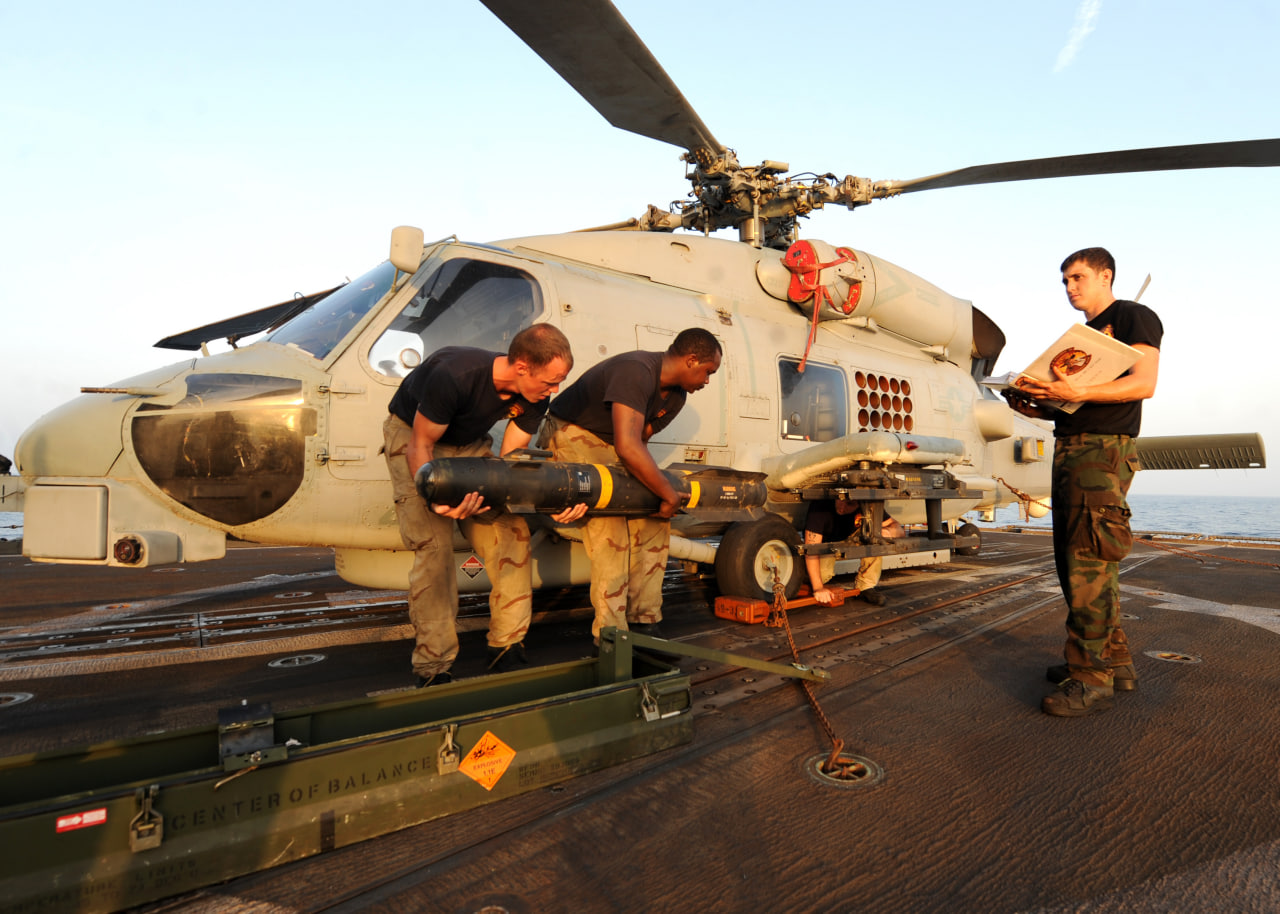Installing AGM-114 Hellfire missile on MH-60B Seahawk helicopter